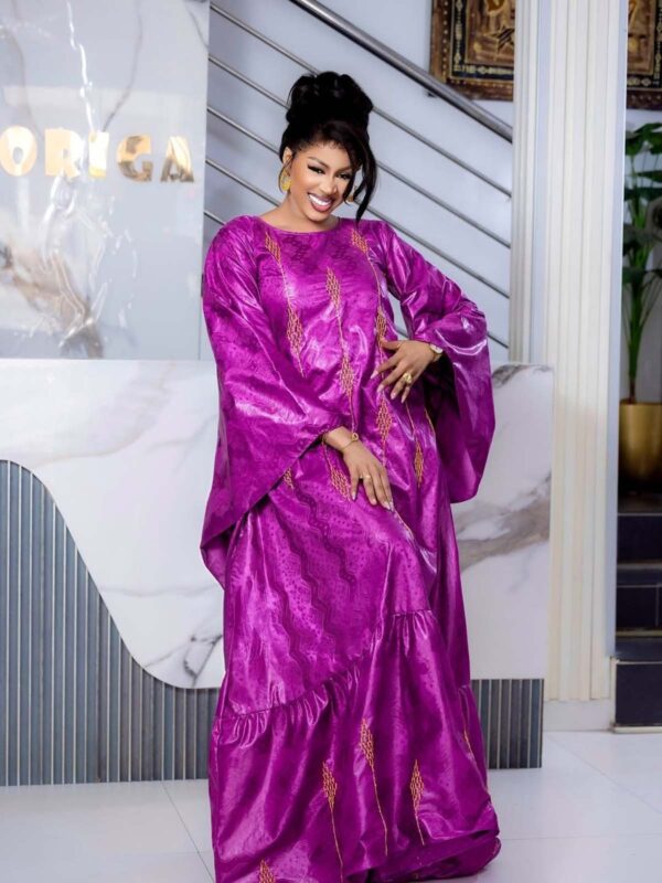 Bazin wedding guest dress with flared sleeves and flowing maxi design