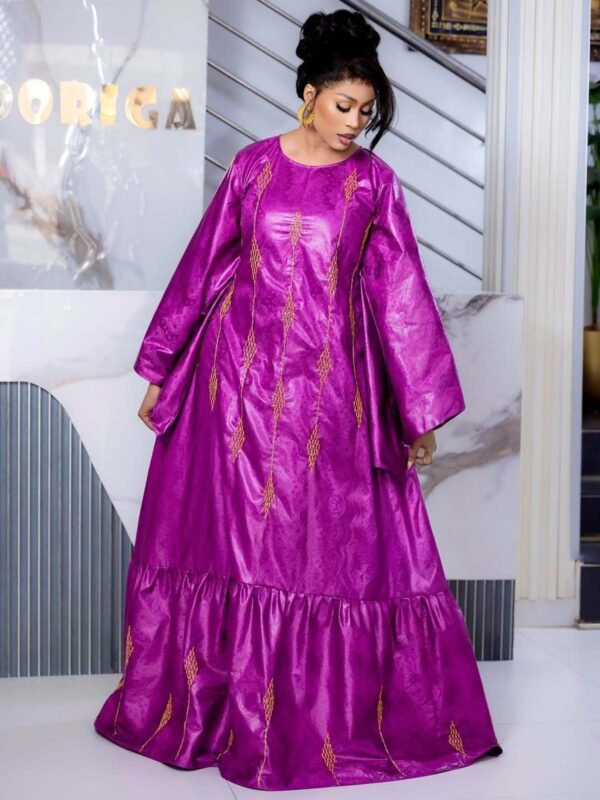 Bazin wedding guest dress with flared sleeves and flowing maxi design