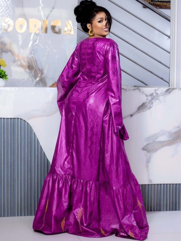 Bazin wedding guest dress with flared sleeves and flowing maxi design