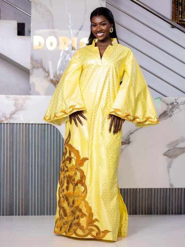 Look effortlessly put-together in this beautiful bazin dress with matching headwrap. The bright yellow Getzner boubou features elegant gold embroidery on the dramatic bell sleeves and hem. Fully custom-made to your exact measurements and includes the coordinating headwrap. Ideal for weddings, Eid celebrations, engagements, and photoshoots. Enjoy reliable worldwide delivery.